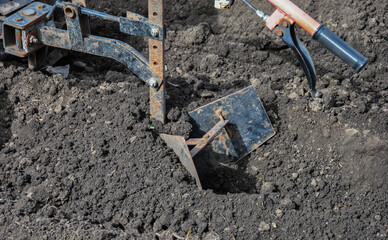 walk-behind tractor plow in the ground. agriculture plowing the land
