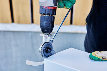 Metal cutter sheet drill attachment is used for cutting roofing iron when finishing window openings.