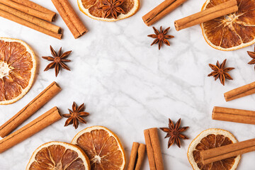Cinnamon sticks and anise on a textured background. Cinnamon roll and star anise. Spicy spice for baking, desserts and drinks. Fragrant ground cinnamon.Place for text. copy space.