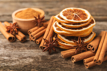 Cinnamon sticks and anise on a textured background. Cinnamon roll and star anise. Spicy spice for baking, desserts and drinks. Fragrant ground cinnamon.Place for text. copy space.