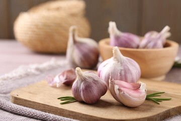 Bulbs and cloves of fresh garlic on table, closeup. Space for text