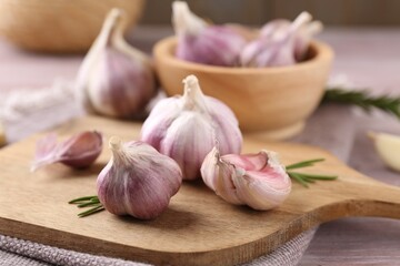Bulbs and cloves of fresh garlic on table, closeup