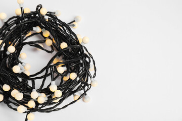 Beautiful Christmas lights on white background, top view