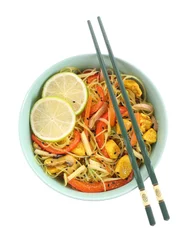 Fotobehang Stir-fry. Delicious cooked noodles with chicken and vegetables in bowl isolated on white, top view © New Africa