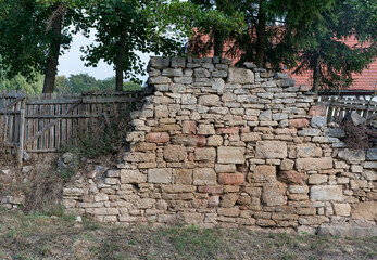 Überreste einer Sandstein Mauer in einem Garten