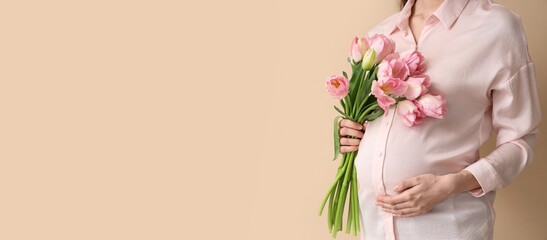 Young pregnant woman with bouquet of beautiful flowers on beige background with space for text