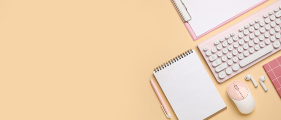Wireless keyboard with computer mouse, earphones and office stationery on yellow background with space for text