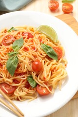 Vegetarian meal. Tasty pasta with fresh tomatoes and basil on table, closeup