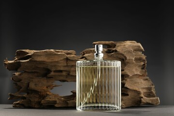 Luxury men`s perfume in bottle on grey table