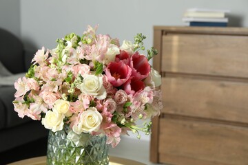 Beautiful bouquet of fresh flowers on table in room, space for text