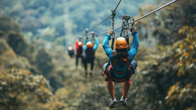 A group of friends enjoying a thrilling zip-line experience over a lush canopy.