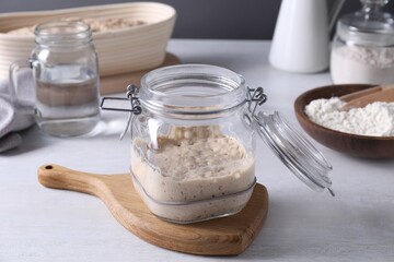 Sourdough starter in glass jar on light table