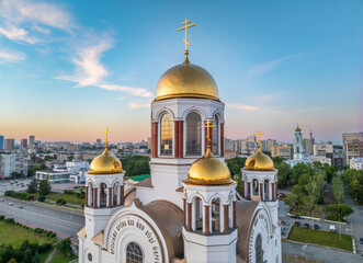 Summer Yekaterinburg and Temple on Blood in beautiful clear sunset.. Aerial view of Yekaterinburg, Russia. Translation of the text on the temple: Honest to the Lord is the death of His saints. - obrazy, fototapety, plakaty