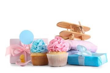 Delicious cupcakes with gift boxes and pacifiers on white background. Gender reveal party concept