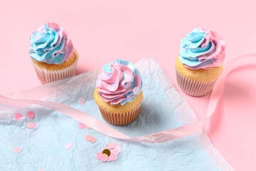 Delicious cupcakes with decor on pink background. Gender reveal party concept