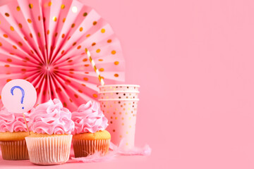Delicious cupcakes with question mark and decor on pink background. Gender reveal party concept