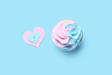 Delicious cupcake with question mark on blue background. Gender reveal party concept