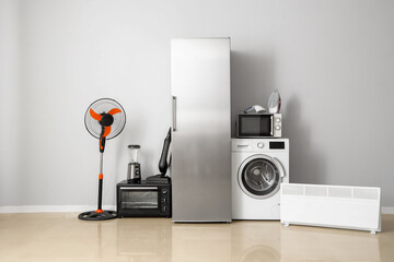 Many different household appliances near white wall