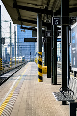 Brno, Czech Republic - March 18, 2024: Train platform at the main station in the city center with the modern future in the background. - obrazy, fototapety, plakaty