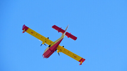 fire extinguisher plane yellow red canadair wing 43 fire flying cl-415 blue sky background