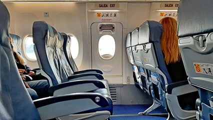 spacious seats emergency exit airplane passengers comfort price security - obrazy, fototapety, plakaty