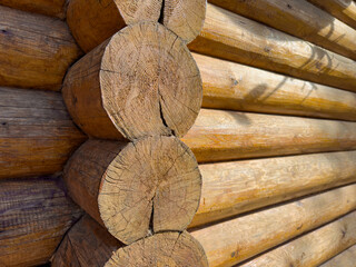 Logs of a wooden house in close-up on a sunny day, a bathhouse, the hut