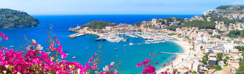 view of Port Soller harbour from above, Mallorca at summer with flowers, Spain, web banner