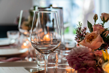 wedding decoration with wine glasses, candle lights and flowers