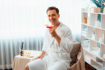 Beauty or body treatment spa salon vacation lifestyle concept with man wearing bathrobe relaxing...