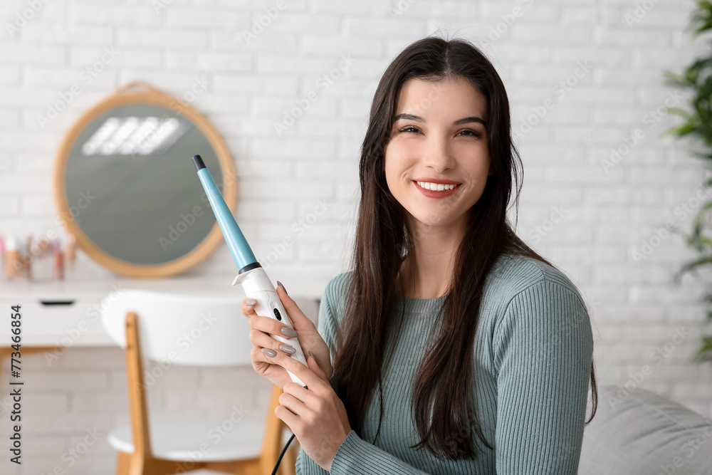 Canvas Prints Beautiful young happy woman with curling iron at house