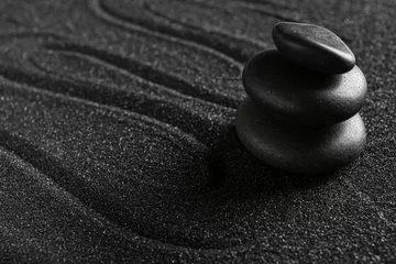 Poster Im Rahmen Spa stones on black sand with lines, closeup. Zen concept © Pixel-Shot