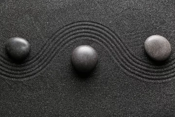  Spa stones on black sand with lines. Zen concept © Pixel-Shot