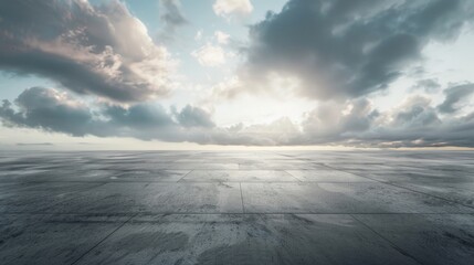 An empty concrete floor with a cloudy sky in the background. Suitable for various industrial or outdoor themed projects