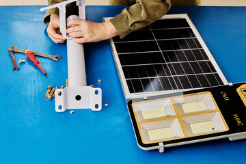 DIY assembly of mounting bracket for holder of solar panel and an LED street light.