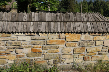 The wall is made of sandstone covered with pickets