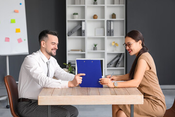 Human resources manager interviewing male applicant in office