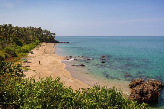 Few people at the idyllic Nui Beach in Koh Lanta, Thailand, on a sunny day. Beautiful tropical landscape viewed from above.
