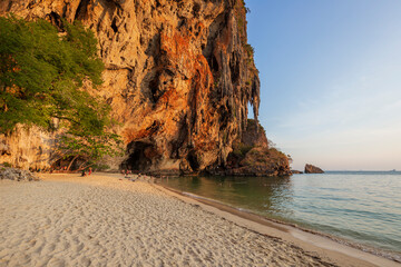 Scenic view of the stunning Phranang (Phra Nang) Cave Beach with few people and steep limestone...