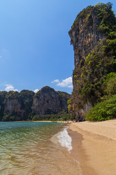 Scenic view of the Tonsai Beach and high limestone karst cliffs in Railay, Krabi, Thailand, on a sunny day.