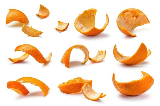 A collection of orange peels on a white surface. Ideal for food and nutrition concepts