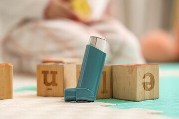 Asthma inhaler with cubes in pediatric clinic, closeup