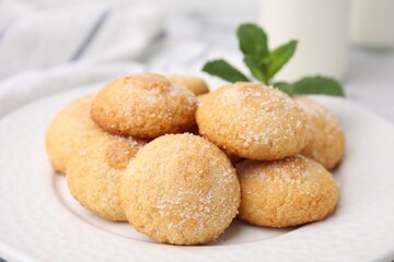 Tasty sweet sugar cookies and mint on table, closeup