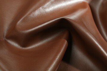 Brown natural leather as background, closeup view