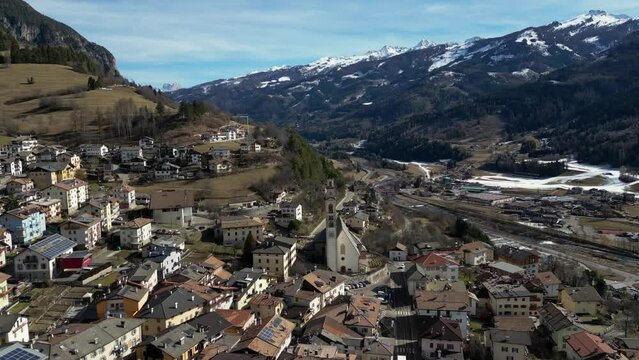 Stunning parallax Drone of Tesero val di fiemme with the mountains in background, Dolomites Italy Europe 2024