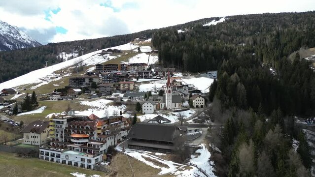 Stunning Aerial shot of Valdaora Parish Church St. Wolfgang in Dolomites Italy Europe