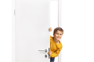 Boy hiding behind a door