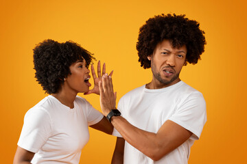 African american millennial couple have fight on yellow background