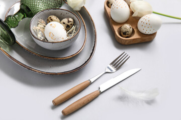 Stylish cute table setting for Easter celebration on grey background