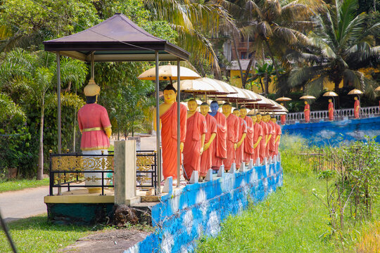 row of Buddhist monk statues in Dambulla