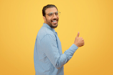 Man giving a thumbs up with a cheerful expression